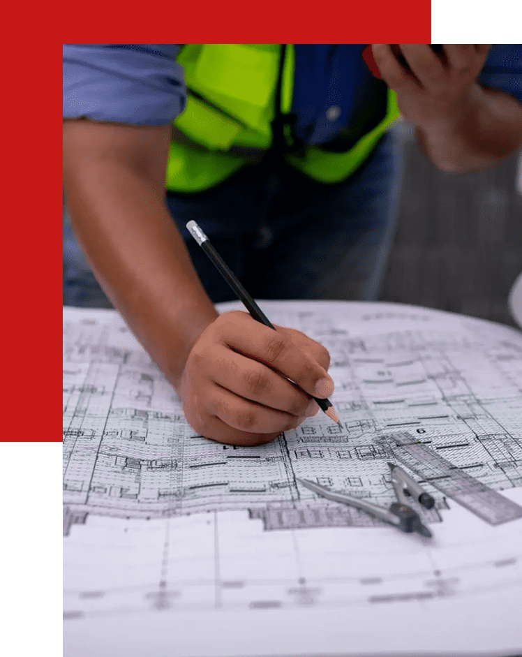 Person drawing architectural plans with a pen and ruler.